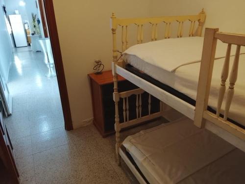a bedroom with a bunk bed next to a hallway at Rustic Chalet With Easy Golf Beach Access Oliva Nova in Oliva