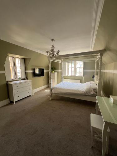 a bedroom with a bed and a dresser and window at West End Beds in Dundee