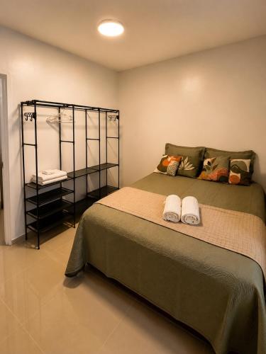 a bedroom with a bed with two towels on it at Ap Go travel in São Luís