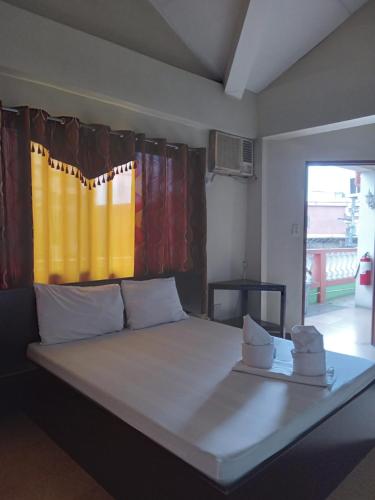 a bedroom with a bed with towels on it at Central View Apartelle in Angeles
