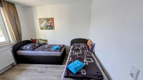 a bedroom with a bed and a small bed and a window at Ferienwohnung in Birkenwerder mit Balkon in Birkenwerder