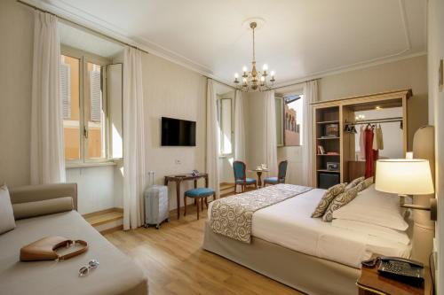 a bedroom with a bed and a desk and a chair at Hotel Della Torre Argentina in Rome