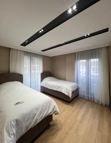 a bedroom with two beds and a large mirror at Riviera Villa Kemer in Agva