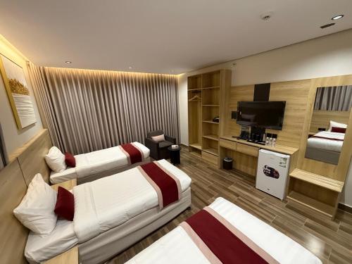 a hotel room with two beds and a television at فندق روح المدينة in Medina