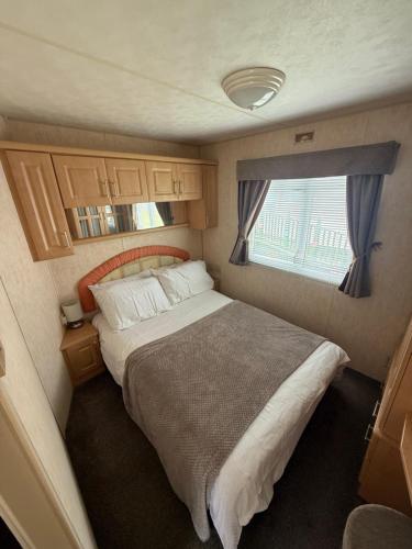 a bedroom with a large bed in an rv at Jemmas Holiday Home in Arbroath