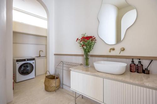 a bathroom with a sink and a washing machine at 2BR Pool Villa Bingin w Ocean View Rooftop - Tasanaa in Badung