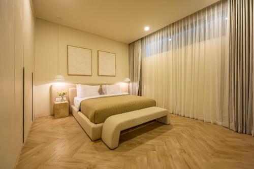 a hotel room with a bed and a window at 2BR Pool Villa Bingin w Ocean View Rooftop - Tasanaa in Badung