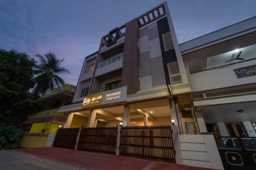 a building with a fence in front of it at Itsy Hotels Snowdrop in Coimbatore
