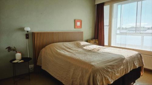 a bedroom with a bed and a large window at Villa Astrid in Pietarsaari
