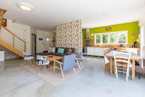 a living room and kitchen with a table and a couch at Maison Au Petit Bonheur in Argenton-sur-Creuse