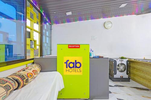 a room with a bed and a yellow box at FabHotel Mahi Resort in Aurangabad