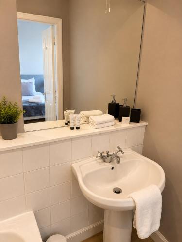 a white bathroom with a sink and a mirror at The Anglers Inn in Guildtown