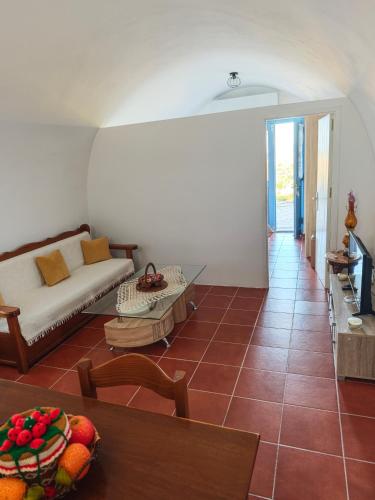 a living room with a couch and a table at Kastri 2 in Kythira