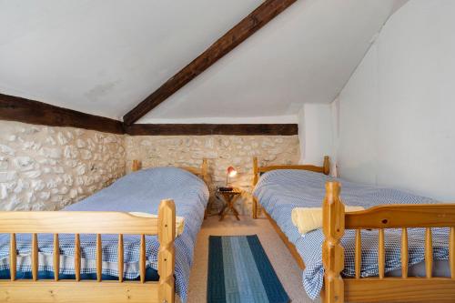 a bedroom with two beds in a attic at Villa Esperance in Grand Brassac