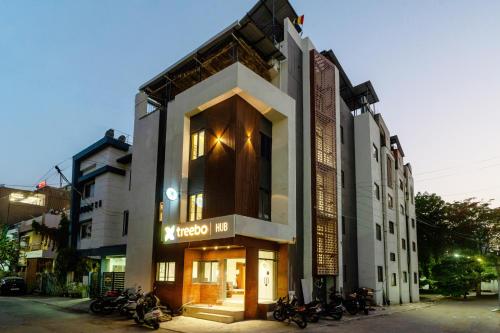 a building with motorcycles parked in front of it at Treebo Hub in Indore