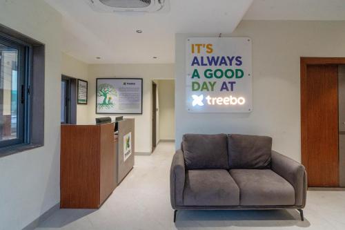 a waiting room with a chair and a sign at Treebo Hub in Indore
