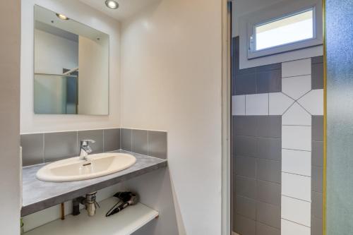 a bathroom with a sink and a mirror at Gîte Gignac Vallée De L'hérault in Gignac