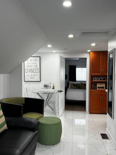 a living room with a couch and a table and a kitchen at Niagara Escape Loft in St. Catharines