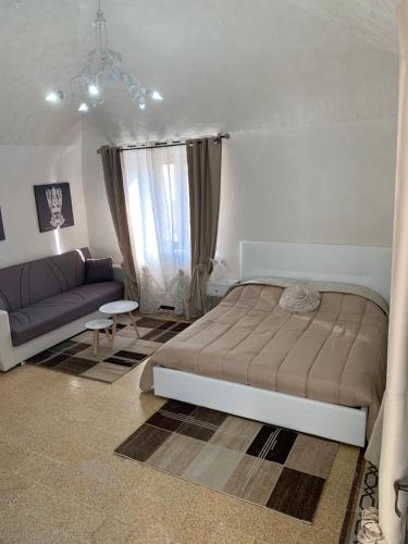 a bedroom with a bed and a couch at Sicilia Ambiente in Montedoro