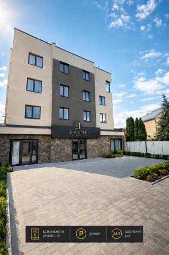 a building with a sign in front of it at EVURI Rooms in Uzhhorod