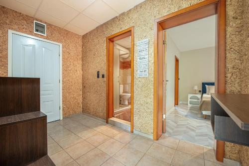 a bathroom with a walk in shower and a door at Messambria Beach Apartments in Sveti Vlas