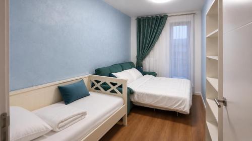 a small room with two beds and a window at Spacious 3-Room Apartment - NEW Building in Bucharest
