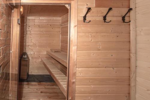 a sauna is shown with a wooden wall at The Nest Apartment in Sovata