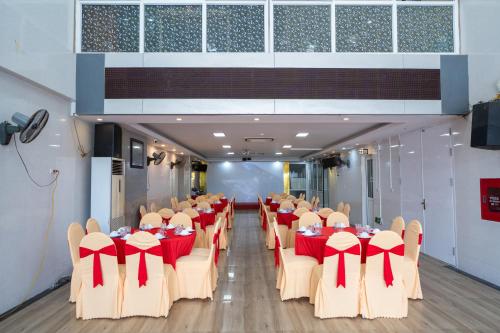 a conference room with tables and chairs with red bows at SAMMY Hotel - Khách sạn SAMMY in Giáp Vinh Yên