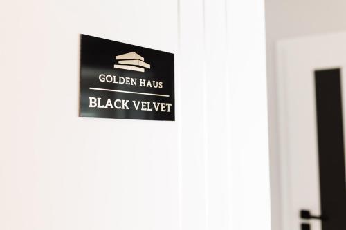 a sign on a door that reads black wastewater at GOLDEN HAUS Opole - Black Velvet & Dark Elegance in Opole