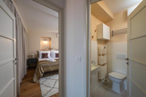 a bathroom with a bed and a toilet in a room at Villa San Martein in Rovinj