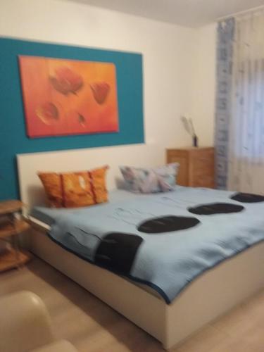 a bedroom with a bed with a painting on the wall at FERIENWOHNUNG Marina in Bad Ems
