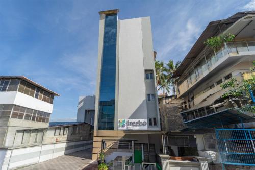 a building with a tall tower in a city at Treebo Regalia, Near Medical College & Pattom in Trivandrum