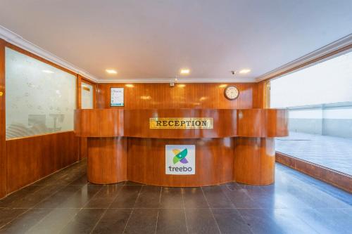 a lobby with a reception desk in a building at Treebo Regalia, Near Medical College & Pattom in Trivandrum
