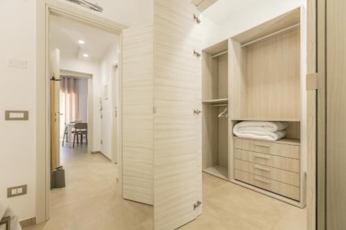 a walk in closet with a sliding door at Nova Suite in Calatafimi