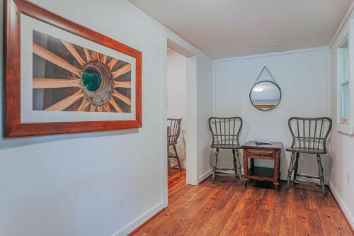 a hallway with chairs and a table and a painting at Bluebird Cottage in Roseland