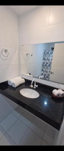 a bathroom with a sink and a mirror at Ecopousada Miriti in Belém