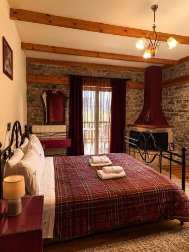 a bedroom with a bed with towels on it at Village Inn in Ano Chora