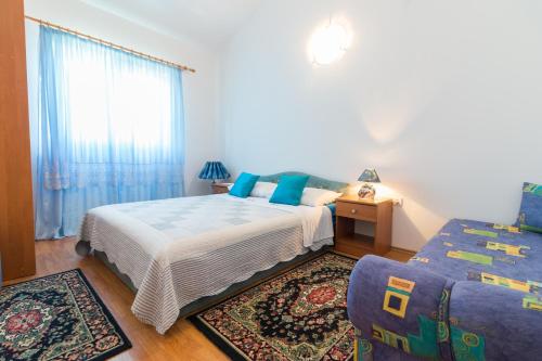 a bedroom with two beds and a window at Apartments Bavaria in Baška