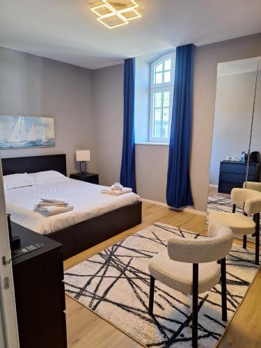 a bedroom with a bed and a table and chairs at Villa Damseaux in Spa