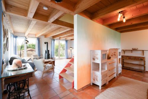 a living room with wooden ceilings and a table at Atempause in Fehmarn