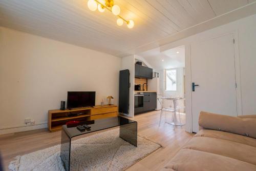 a living room with a couch and a table at l'Onyx in La Rochelle