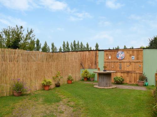 a backyard with a table and a fence at Homestead in Long Sutton