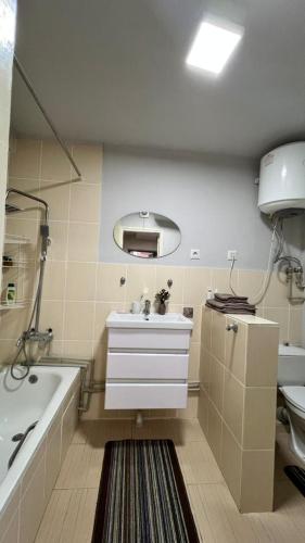 a bathroom with a tub and a sink and a bath tub at Asia-palace in Chon-Sary-Oy