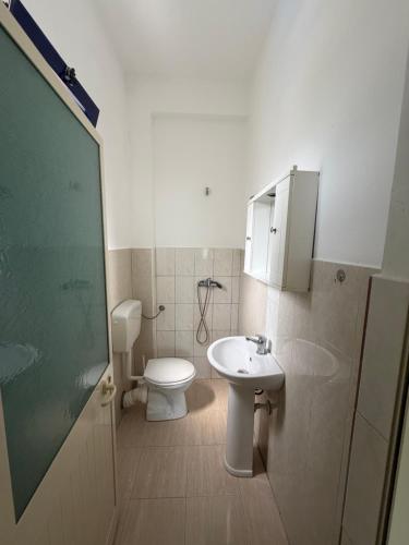 a bathroom with a toilet and a sink at Hotel Parking Pika in Shëngjin