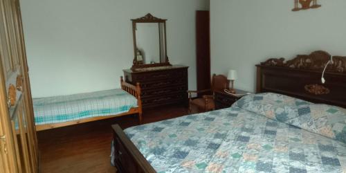 a bedroom with a bed and a dresser and a mirror at I Ponti in Fanano