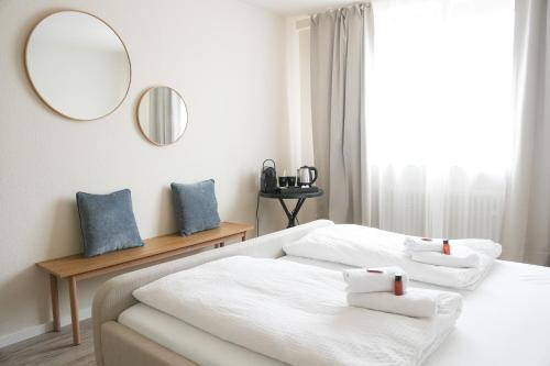 two beds in a room with a mirror at KasselRooms Design Studio in Kassel