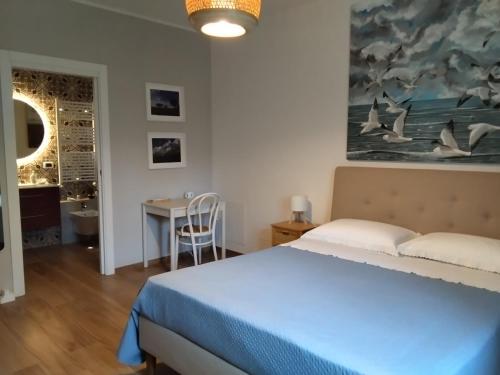 a bedroom with a bed and a table and a painting at B&B Galleria 37 in Canosa Sannita