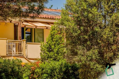 a yellow house with trees in front of it at Hotiday Marina di Cecina in La Cinquantina