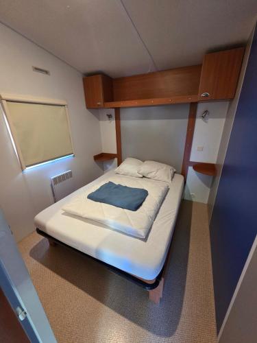 a small bedroom with a bed in a small room at L évasion in Saint-Thomas-en-Royans