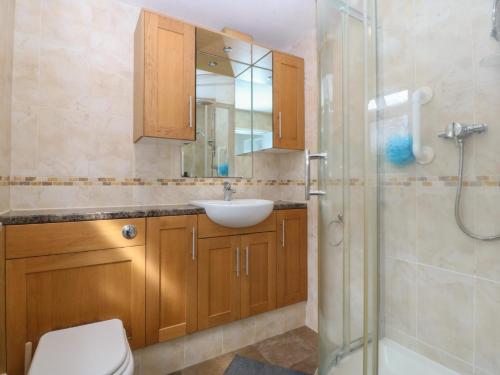 a bathroom with a toilet and a sink and a shower at Gwynfa in Colwyn Bay